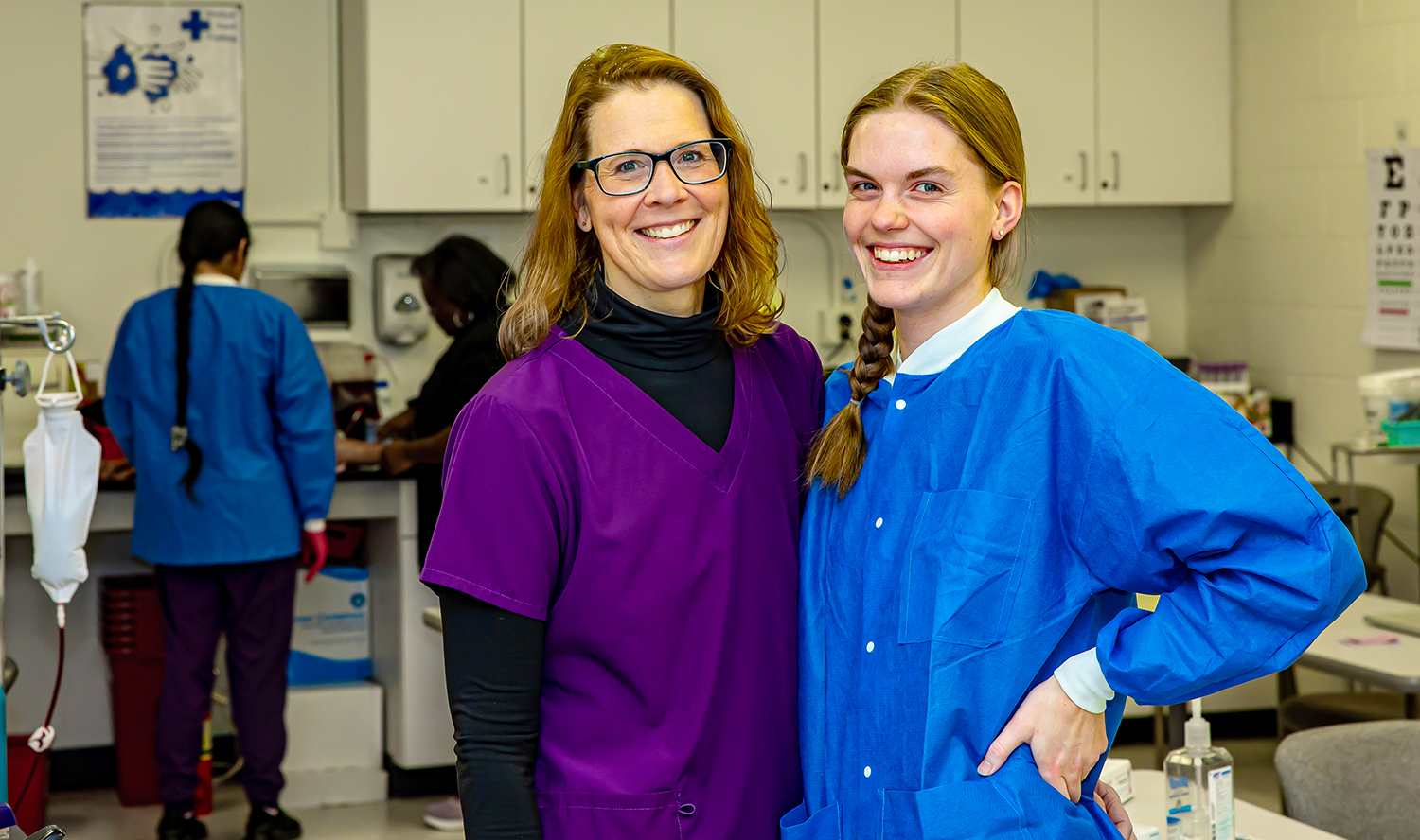 Julie and Emily Friedrichsen pose inside a Medical Assisting classroom.